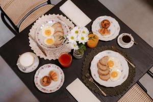 a table topped with plates of eggs and biscuits at Villa del Brolo - Famiglia Furia in Mezzane di Sotto