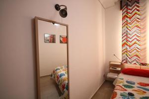 a mirror in a room with a bed and a mirror at B&B Santiago in Gela