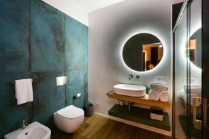 a bathroom with a sink and a mirror at NILO RELAIS a san domenico maggiore in Naples