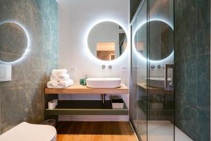 a bathroom with a sink and a mirror at NILO RELAIS a san domenico maggiore in Naples