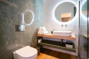 a bathroom with a sink and a mirror at NILO RELAIS a san domenico maggiore in Naples +40 photos