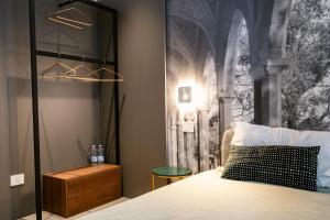 a bedroom with a bed and a wall mural at NILO RELAIS a san domenico maggiore in Naples