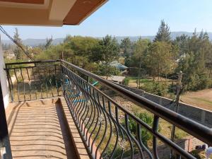 a balcony with a view of a train track at Cool Breeze Penthouse - Nati Apartment in Kisumu