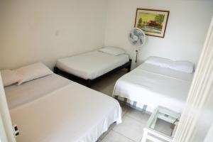 a room with two beds and a fan at APARTAMENTO CAMPESTRE EN EJE CAFETERO in Manizales