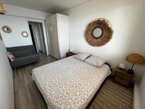 a bedroom with a bed and a mirror on the wall at Beautiful beachfront apartment in Carry-le-Rouet