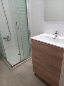 a bathroom with a sink and a shower at Casa Anita in Luarca +17 photos