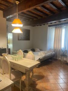 a bedroom with a bed and a table and chairs at Pietre Antiche Loft in Manciano