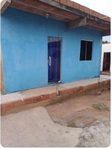 un edificio azul con una puerta azul en Quintal Compartilhado - Casa Temporada, en Armacao dos Buzios