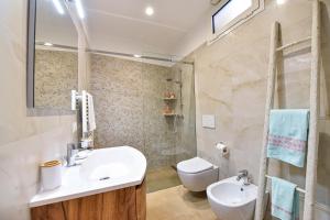 a bathroom with a sink and a toilet at La Dimora di Peppe in Locorotondo