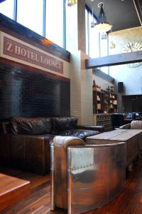 a hotel lounge with leather furniture in a room at Z NYC Hotel in Queens