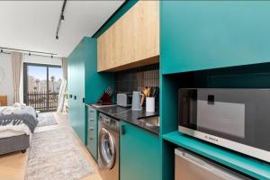a kitchen with a washer and dryer in a room at Luxe at Nine Palms Near Canal Walk in Cape Town