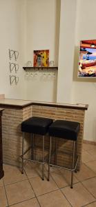 two stools sitting at a bar in a room at Casa Stefano in Casperia