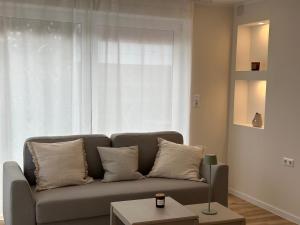 a living room with a couch and a window at TIDE Norddeich in Norddeich