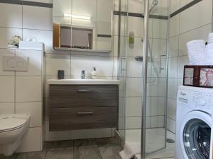 łazienka z umywalką i pralką w obiekcie Warmbad Apartments w Villach +37 zdjęć