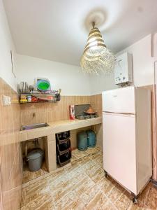 a kitchen with a white refrigerator and a counter at Surf and Stay Anza - Surf Territory in Agadir