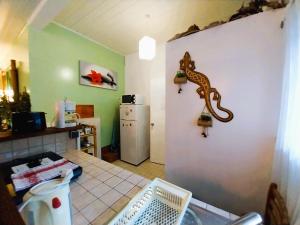 a kitchen with a counter and a refrigerator at TAHITI - Erima POOL Studio in Arue