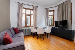 a living room with a couch and a table and chairs at Exclusive House with 2 Apartments including 4 Bedrooms and 4 Bathrooms in Total in Istanbul