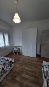 a bedroom with a bed and a desk in it at Apartment A&D Home Imola Centro in Imola