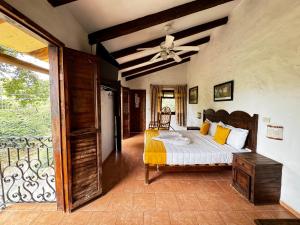 a bedroom with a bed and a ceiling fan at Posada La Querencia in Xico