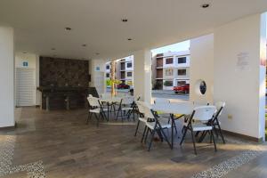 een eetkamer met tafels en stoelen en een piano bij Departamento Close to Beach - Azul pacifico in Mazatlán