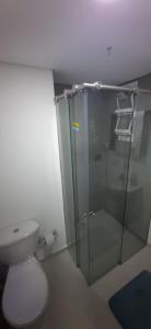 a bathroom with a toilet and a glass shower at Medellín Apartment Loft in Medellín