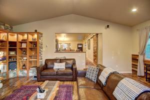 a living room with a leather couch and a chair at Whitefish Luxury Escape w hot tub, fenced in yard in Whitefish