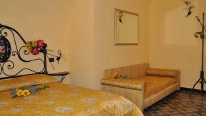 a bedroom with a couch and a bed and a chair at AgriIlGeco V - Loggia sul Faudo - by HOST4U in Civezza