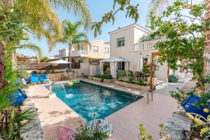 a swimming pool in the backyard of a house at Villa Myria, 3BD, Private Pool, Garden, BBQ, Near the Beach in Kisonerga in Paphos