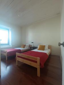 a bedroom with two beds and a couch at Casa dos Narizes in Angra do Heroísmo