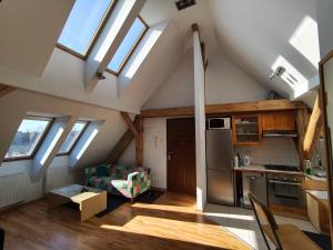 a kitchen and living room with skylights in an attic at Apartament Gliwice Centrum in Gliwice