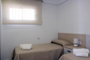 A bed or beds in a room at Apartamento Quesada