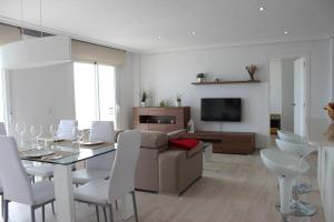 a living room with a couch and a table and chairs at Apartamento Quesada in Pilar de la Horadada