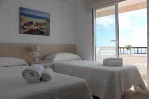 A bed or beds in a room at Apartamento Quesada