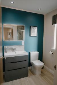 a bathroom with a white sink and a toilet at Stanloch Barn - new barn conversion, well equipped, EV in Glencaple +11 photos