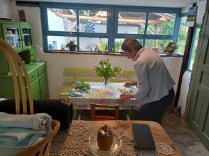 a woman standing at a table in a room at Vila Dika in Poganovo