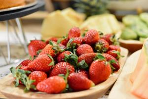 a pile of strawberries in a bowl on a table at Palermo Inn Boutique Arte in Palermo
