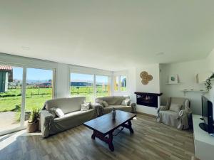 a living room with two couches and a coffee table at Villa Ikigai Costa in Villaviciosa
