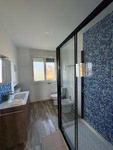 a bathroom with a shower and a sink and a toilet at Villa Ikigai Costa in Villaviciosa +23 photos