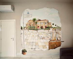 a wall mural of a man in front of a building at Palermo Inn Boutique Arte in Palermo