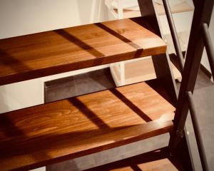 a set of wooden stairs with shadows on the floor at Palermo Inn Boutique Arte in Palermo