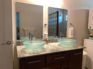 two sinks in a bathroom with a large mirror at Luxurious One Bedroom Poolside Punta Chame Resort in Pajonal +14 photos