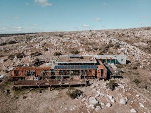 an aerial view of a building in the middle of a hill at Eco-Suite Estación Penitente in Minas
