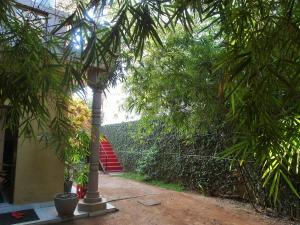 a walkway with trees and a staircase in a building at Villa Two Residence in Mount Lavinia
