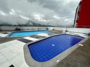 a large blue swimming pool on top of a building at atardeceres in Armenia
