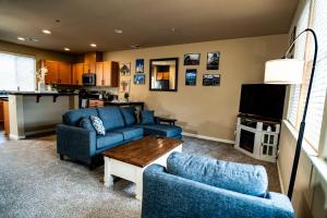 a living room with two blue couches and a table at Eat-Sleep-Stroll-Repeat! Walkable Midtown 2BR Home in Reno