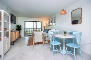 a living room with a table and chairs and a dining room at Spacious 2BR Condo With Beach Views Sanibel Island 1C2 in Sanibel