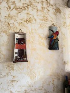 a painting of a bird hanging on a wall at Guanentina Casa Campestre-Villanueva, cerca Barichara in Villanueva +23 photos