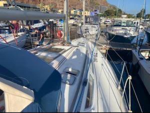 a boat docked in a harbor with other boats at eMeM in Calheta