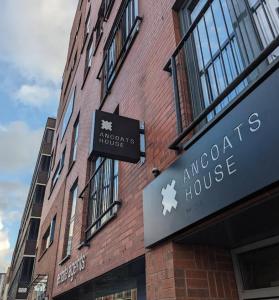 a building with a sign on the side of it at Ancoats 2BR with Private terrace in Manchester
