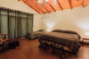 a bedroom with two beds and a couch in it at Tierra Guaraní Lodge in Puerto Iguazú